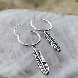 Radiant Silver Feather Earrings