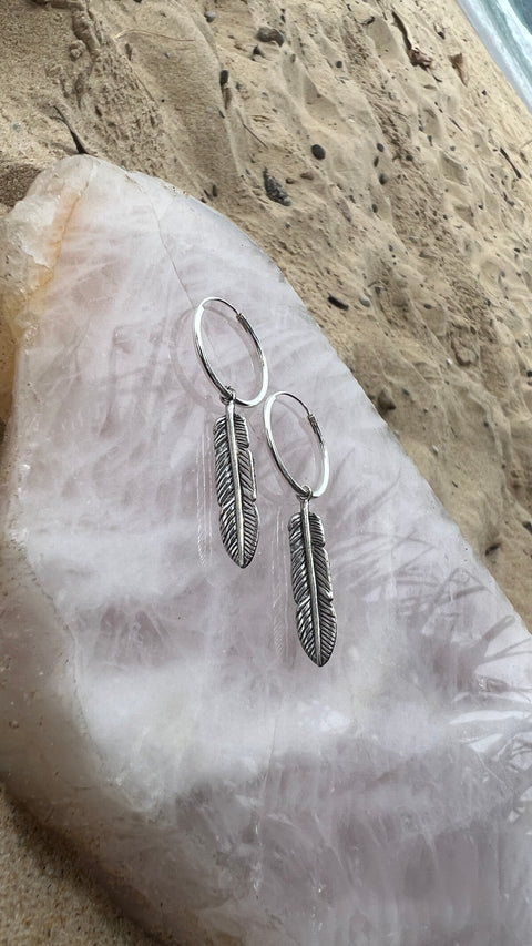 Radiant Silver Feather Earrings