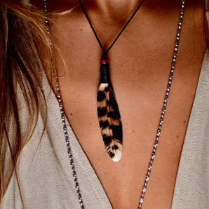 Hand carved feather pendant.