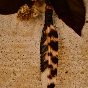 Hand carved feather pendant.