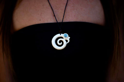Hand carved bone pendant with Paua shell inlay